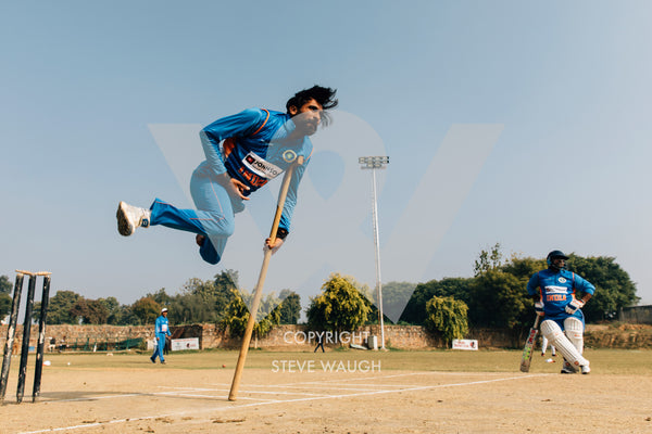 Photograph taken of a pole vaulting cricketer at the Physically Challenged Cricket Association of India.