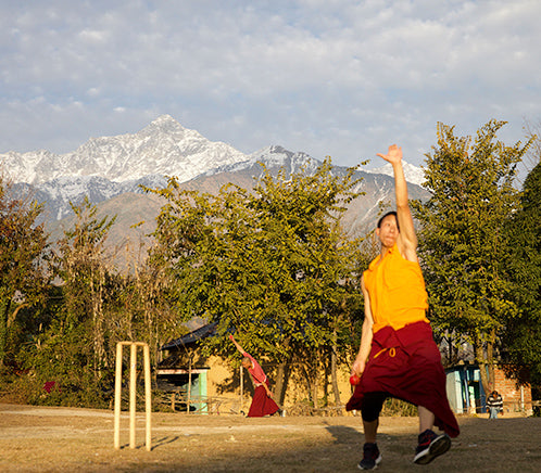 Man bowling infant of a snowy mountain in India