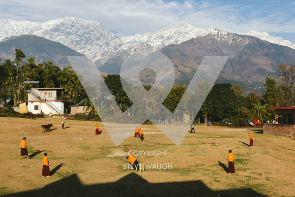 Photograph taken of a Monk cricket match in the foothills of the Himalayas.