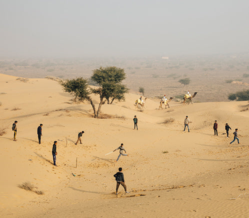 Locals playing a game of cricket in the sandunes.